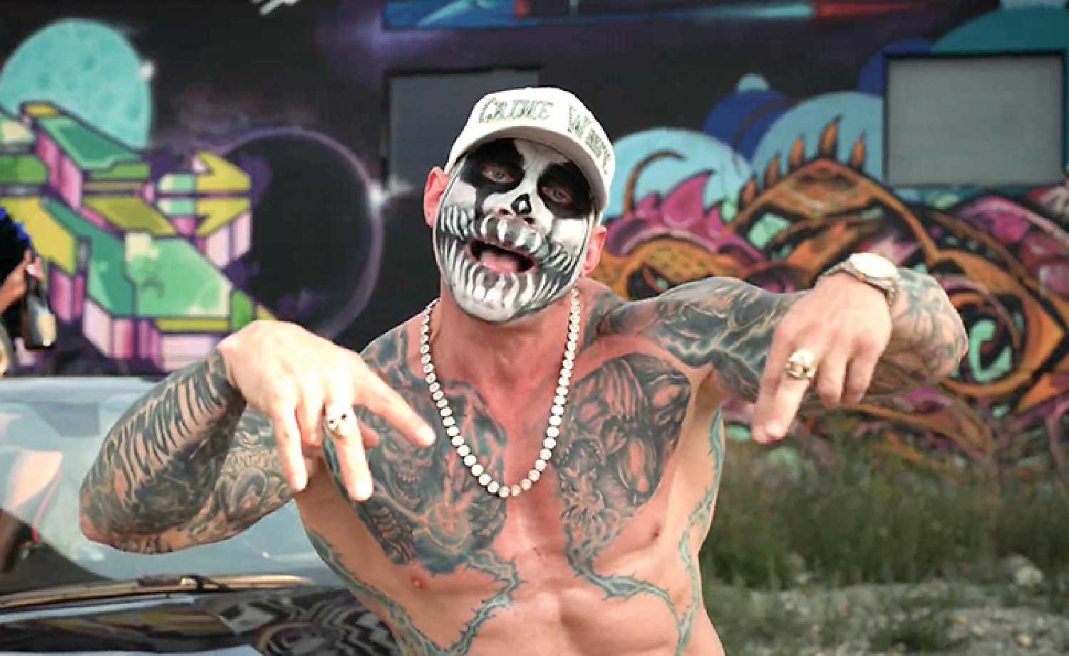 The rapper Decepti Kon in one of his videos. Right: Some of the items seized after searches of properties in Bangor, Brendenbury, Yorkton and the RM of Orkney.